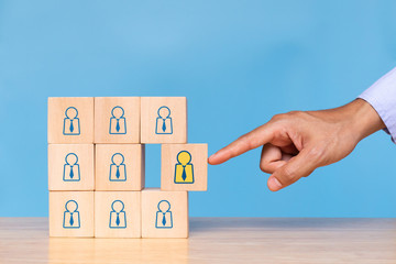 Businessman choose human icon on blue background. Concept of human resources management and recruitment business