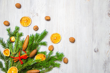 Christmas and New Year composition. Pine branches, cinnamon sticks, dried slices of orange and walnuts. Christmas and New Year concept. Flat lay.