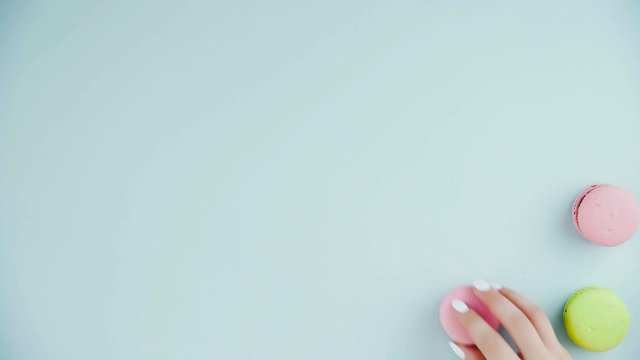 Macaroons or macaron on pastel blue surface. Close up.