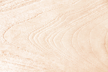 Fototapeta na wymiar Wood texture mild brown background in waves spiral seamless patterns natural line horizontal