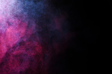 Freeze motion of colored dust explosion isolated on black background.