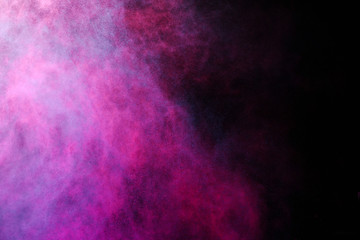 Freeze motion of colored dust explosion isolated on black background.