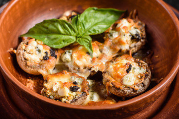 Caps of mushrooms champagne stuffed with four varieties of cheese and baked. Traditional Italian Mushroom Caps stuffed with Feta