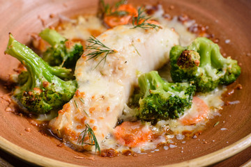 Fresh baked sea fish with broccoli, carrots, vegetables and cheese. Superfood. Vegitarian Menu