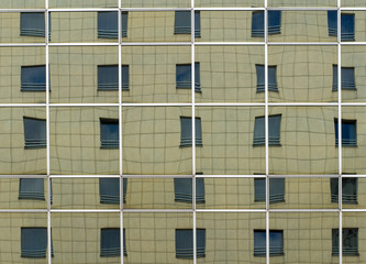 Mirror reflection of the facade of a multi-storey building in large mirrors.