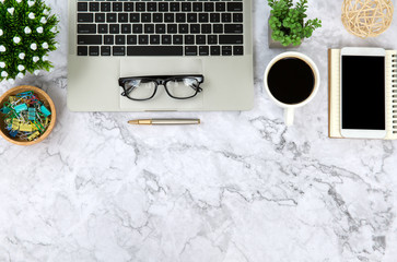 Top view desk,Modern office desk Workspace with laptop computer, coffee cup, glasses,notebook and office supplies for Working background concept,Marble table top