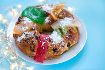 typical portuguese Christmas fruit cake Bolo rei on blue background