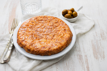 typical spanish food Tortilla on white dish on white wooden background