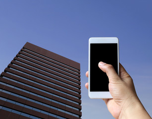 Hand of a man holding a blank smartphone device.