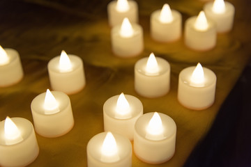 Fototapeta na wymiar Festive blessing for environmentally friendly alternative use of white electronic candle close-up