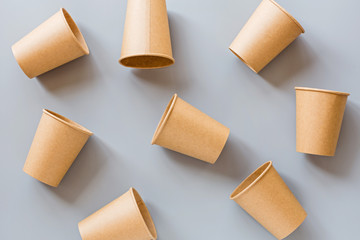 eco natural paper coffee cups flat lay on gray background. sustainable lifestyle concept. zero waste, plastic free items. stop plastic pollution. Top view, overhead, template, Mockup.