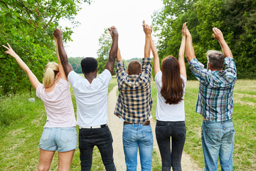 Young people cheer together in the park