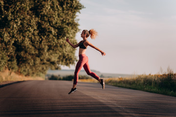 Fototapeta na wymiar Young woman runner running on city bridge road