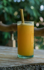 Zero waste concept with reuse bomboo straw, tropical delicious juice, Thai Bali seasonal, cool ice beverage for refreshing in summer on green nature bokeh background