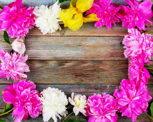 frame bouquet of pink and white peonies flowers close-up on wooden retro background with copy space