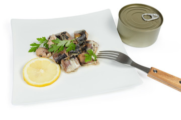 Canned fish on dish with fork, in sealed tin can