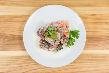 Canned salmon in its own juice with parsley, top view
