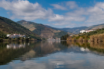 Obraz premium Scenic view of the Pinhao village with terraced vineyards and the Douro River and the Douro Valley, in Portugal; Concept for travel in Portugal and most beautiful places in Portugal