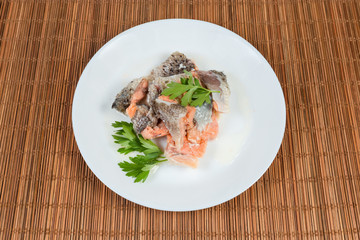 Canned salmon in its own juice with parsley on dish