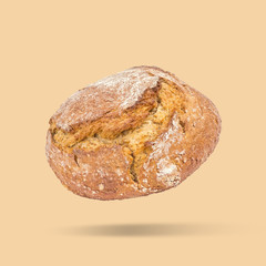 Floating sourdough bread on brown background, minimal view