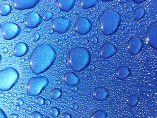 Drops of water on blue metal
