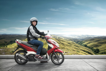 Fototapeta na wymiar Asian motorcycle taxi man with his motorcycle