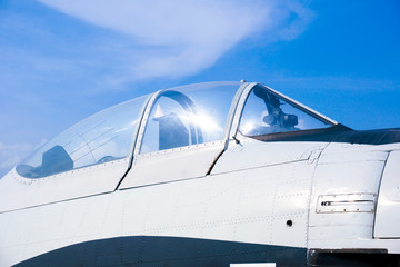 Closeup of military fighter jet cockpit and canopy against a blue sky,aircraft canopy against