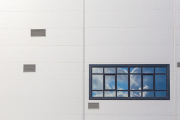 One window on the wall is made of modern materials.Horizontally.