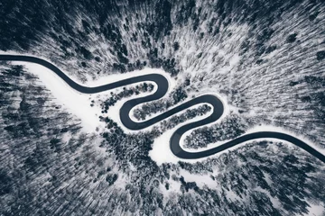 Foto op Aluminium Aerial view of a winter road in the forest © Calin Stan
