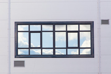 One window on the wall is made of modern materials.Horizontally.