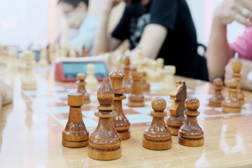 Playing chess people at the table. Chess pieces are placed on a special game table. Concept development and promotion of intellectual games in the world space