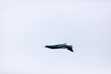 Fototapeta na wymiar Military jet fighter flying upside down performing an inverted flight.