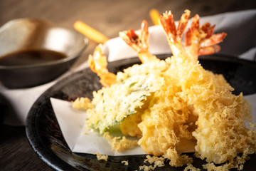 The tempura shrimps with sauce, deep-fried shrimps in the traditional Japanese restaurant.