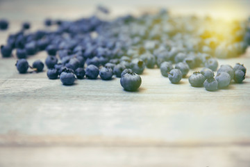 Blueberries on vintage style background. Image is with selective focus. Top view