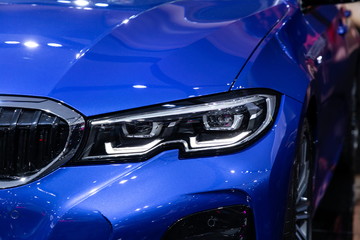 blue car front headlight new design in motor show .