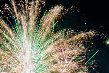 A bunch of white-green fireworks in the night sky