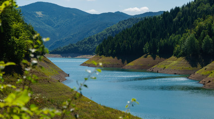 Sun sparkling on a blue Zaovine lake mountain Tara