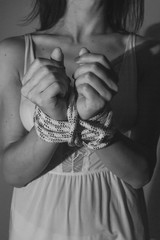 Detail of an attractive hands tied woman