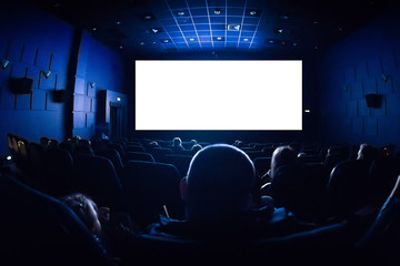 People in the cinema watching a movie. Blank empty white screen