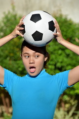Surprised Sporty Asian Female Soccer Player With Soccer Ball