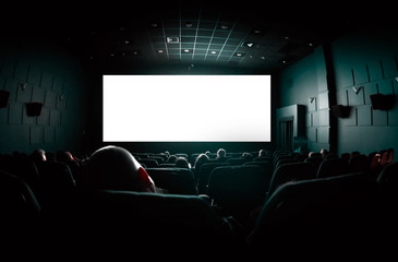 People in the cinema watching a movie. Blank empty white screen - obrazy, fototapety, plakaty