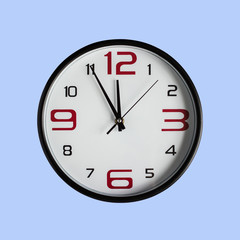 Black clock in front of blue colored background