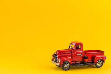 Izhevsk, Russia - July 29, 2019. Red retro toy truck on yellow background.