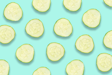 Flat lay composition with slices of cucumber on color blue background
