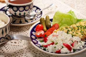 Healthy breakfast, bread with white cheese, scrambled eggs and tomatoes