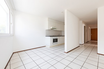 Empty room with vintage kitchen, white tiles and walls