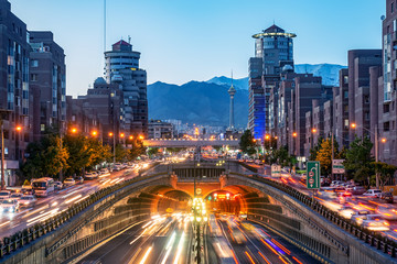 Fototapeta premium 06/05/2019 Tehran,Iran,Famous night view of Tehran,Flow of traffic round Tohid Tunnel with Milad Tower and Alborz Mountains in Background, Tohid Tunnel one of longest urban tunnel in Middle East