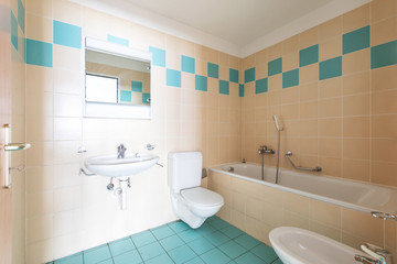 Vintage bathroom with beige and blue tiles