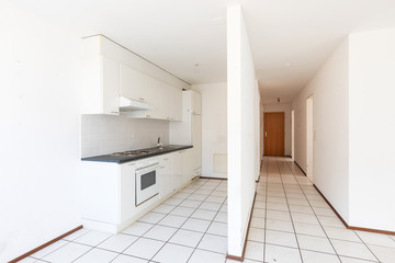 Empty room with vintage kitchen, white tiles and walls
