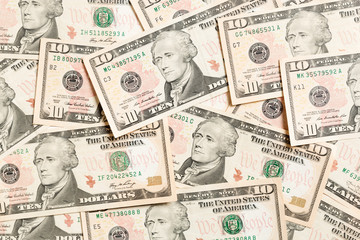 Top view of background made with 10 dollar banknotes. USD cash. American money concept